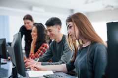 concentrated-blonde-group-young-people-casual-clothes-working-modern-office-min-scaled